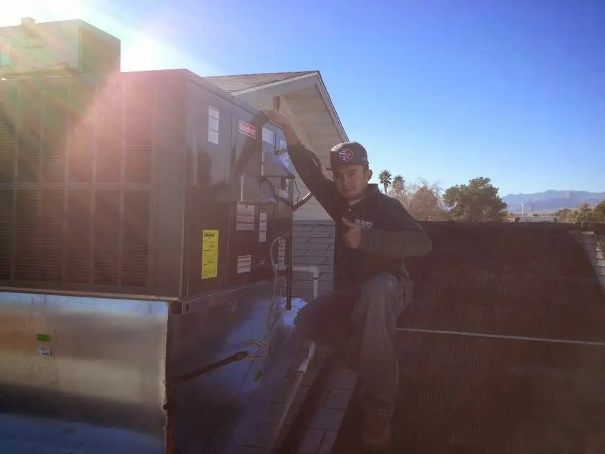 HVAC technician performing Air Duct Repair on a rooftop unit in Parma Heights